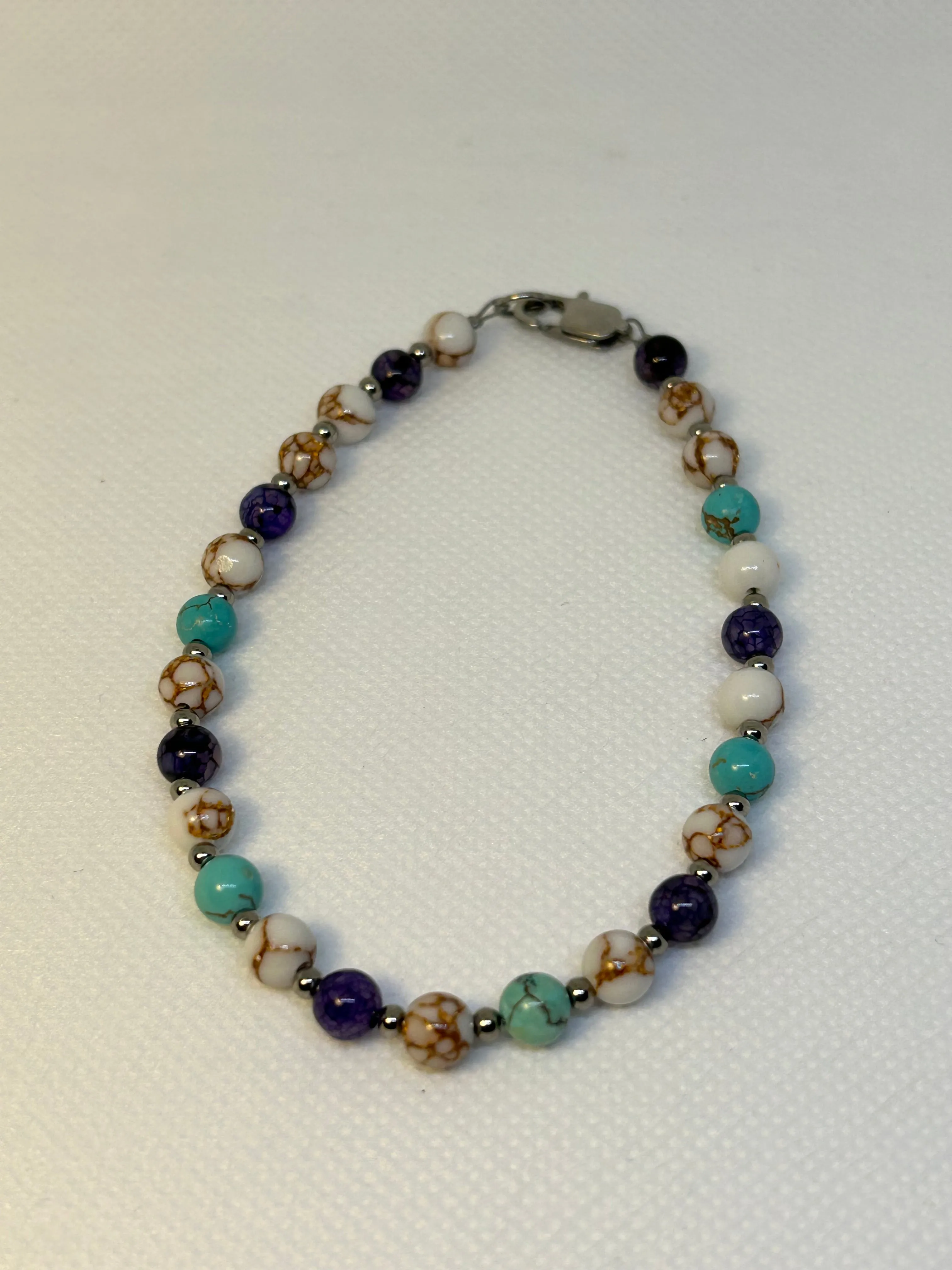 Handcrafted Howlite, purple vein agate, and turquoise ankle bracelet. Hypoallergenic stainless steel beads and clasp.EP145